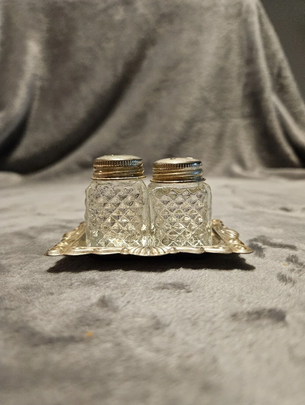Vintage mini crystal glass salt and pepper shakers with a diamond pattern.
